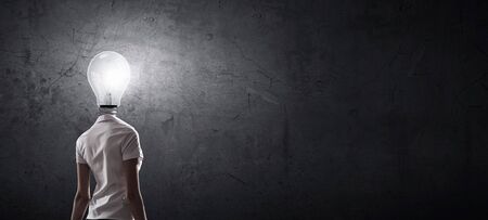 Idea concept with businesswoman and light bulb instead of his headの写真素材