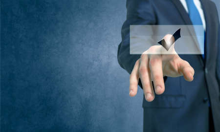 Close up of businessman hand touching icon with fingerの写真素材