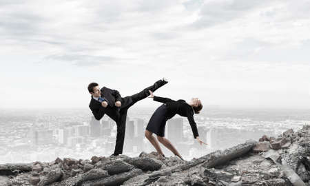Two businesspeople in anger fighting with each otherの写真素材
