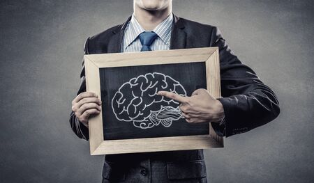 Close up of man holding chalkboard with ideasの写真素材