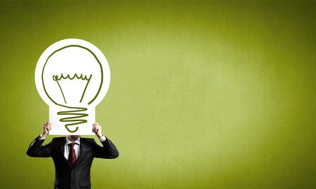 Unrecognizable businessman holding paper covering her faceの写真素材