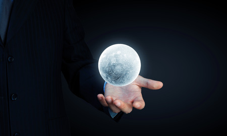 Close of man hands holding moon planetの写真素材