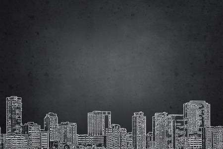 Close up of hand drawing urban buildings with markerの写真素材