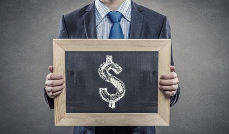 Close up of businessman holding chalkboard with business ideasの写真素材