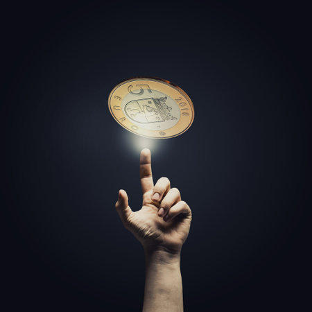 Human hand pointing with finger at euro coin