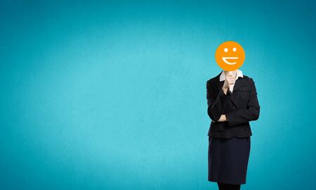 Unrecognizable businesswoman hiding her face behind maskの写真素材