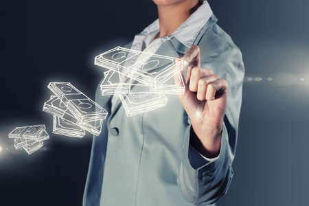 Chest view of businesswoman drawing money banknotes on screenの写真素材