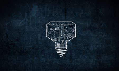 Light bulb with sketches inside on dark backgroundの写真素材