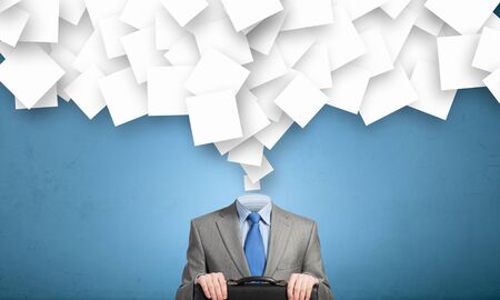 Faceless businessman with pile of papers flying on airの写真素材