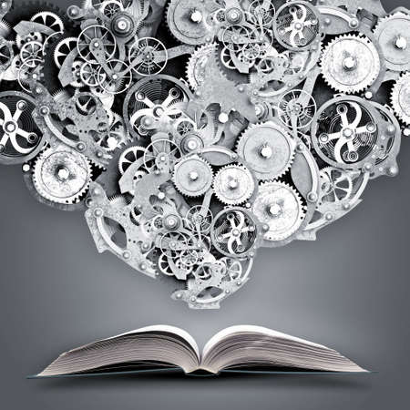 Old opened book with gears and cogwheels flying outの写真素材