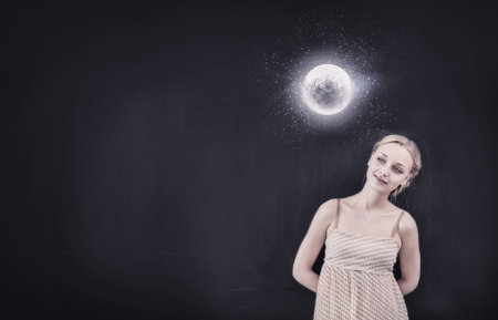 Young pretty smiling woman looking at moon