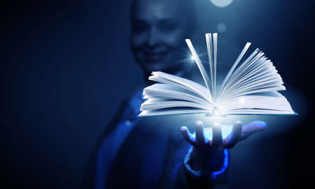 Close up of businesswoman showing media book on palmの写真素材