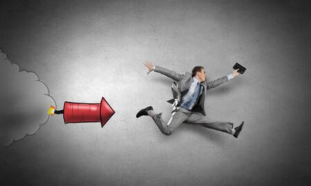 Young speedy businessman running in a hurryの写真素材