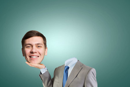 Young headless businesman holding his head in palmの写真素材