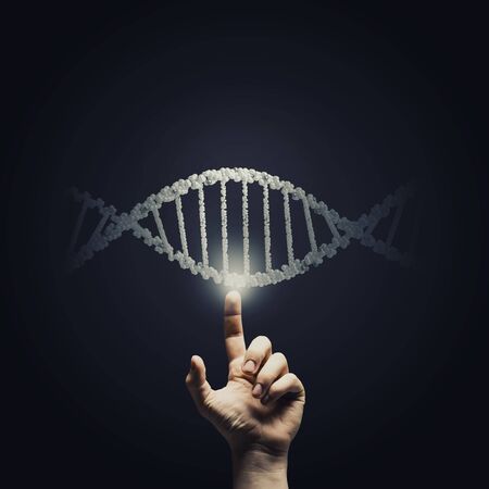 Science concept image of human hand touching DNA moleculeの写真素材