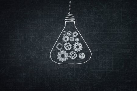 Close up of hand drawing gears mechanism with chalkの写真素材