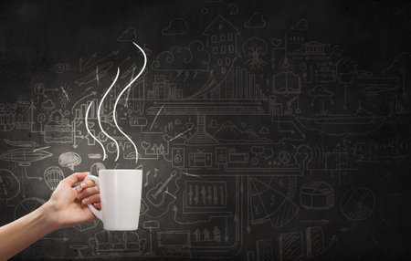 Coffee cup and business strategy sketches on background
