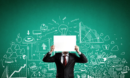 Unrecognizable businessman holding paper covering her faceの写真素材