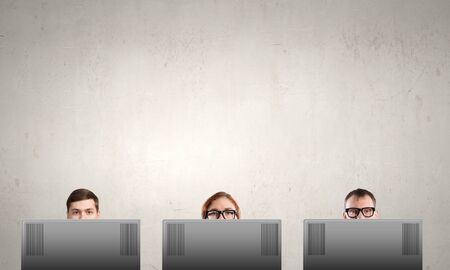 Young people looking out above laptop monitorの写真素材