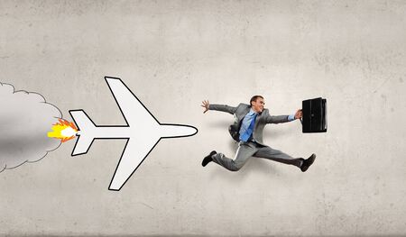 Overworked young businessman being late on airplaneの写真素材