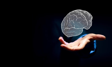 Close up of businessman hand holding brain in palm