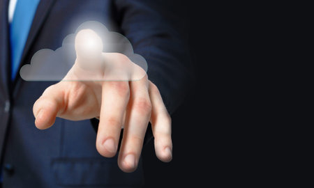 Businessman pressing cloud icon on media screen