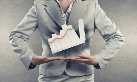 Businesswoman presenting on palms growing income chartの写真素材