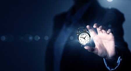 Close up of businessman hand showing clock watch symbolの写真素材