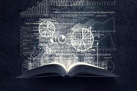 Old opened book with business sketches over black backgroundの写真素材