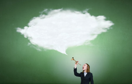 Young businesswoman in suit proclaiming something in hornの写真素材