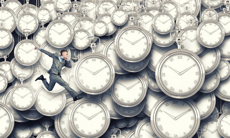 Concept of time with funny businessman running in a hurryの写真素材