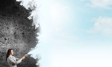 Young pretty businesswoman holding paint brush. Creativity conceptの写真素材