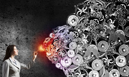 Young pretty businesswoman holding paint brush. Creativity conceptの写真素材