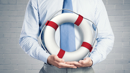 Close up of businessman with life buoy in handsの写真素材