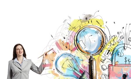 Young pretty businesswoman holding paint brush. Creativity conceptの写真素材