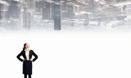 Young confident businesswoman with hand on waistの写真素材