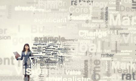 Young businesswoman writing different words on screenの写真素材