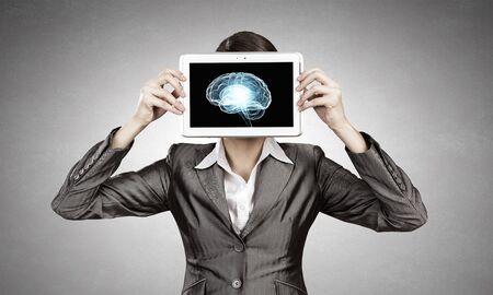 Woman holding tablet pc with brain conceptの写真素材