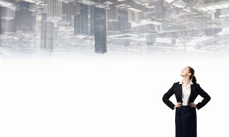 Young confident businesswoman with hand on waistの写真素材