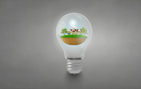Light bulb with concept of ecological construction in itの写真素材