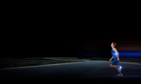 Young running man athlete in blue wearの写真素材