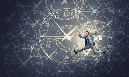 Concept of time with funny businessman running in a hurryの写真素材