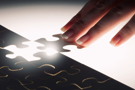 Hand connecting missing jigsaw glowing puzzle piece