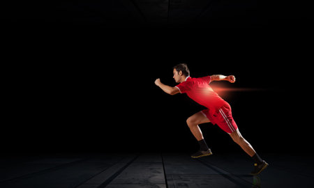 Running man in red sport wear on black 
