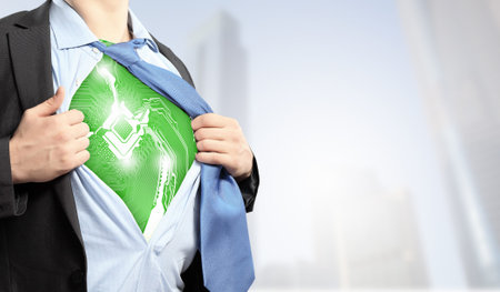 Businessman opening his shirt on chest acting like super heroの写真素材