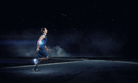 Young running man athlete in blue wearの写真素材