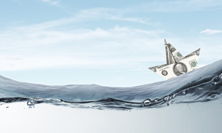 Ship made of dollar banknote floating in water