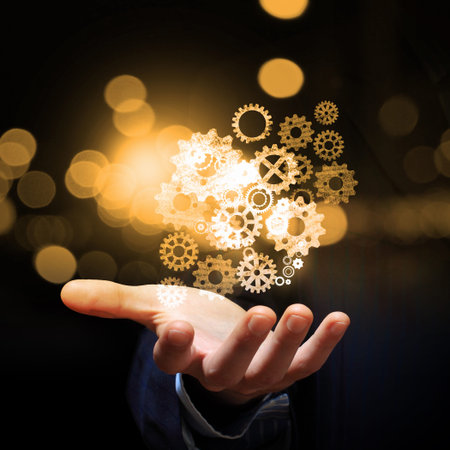 Close up of human hand holding gear iconsの写真素材