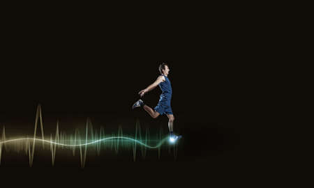 Running man in blue sport wear on black backgroundの写真素材
