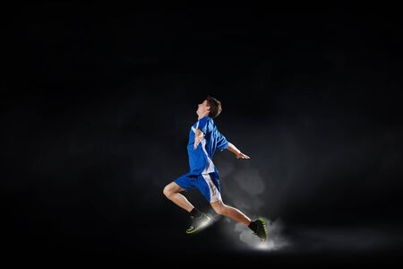 Running man in blue sport wear on black backgroundの写真素材